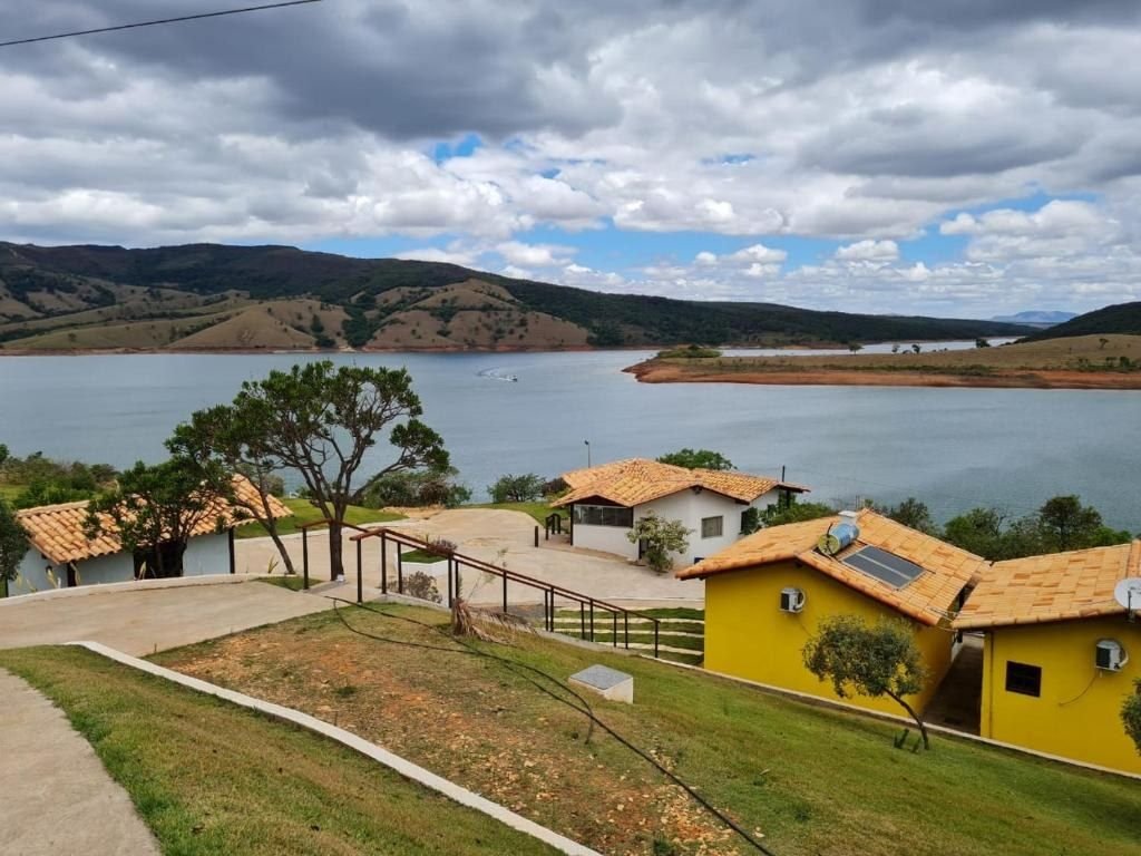 Chalés amarelos com telhado de cerâmica de frente para o Lago de Furnas